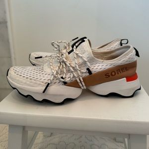 SOREL Kinetic Impact lace sneakers for women. White mesh, tan leather, orange
